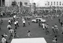 Crowd jumps fence